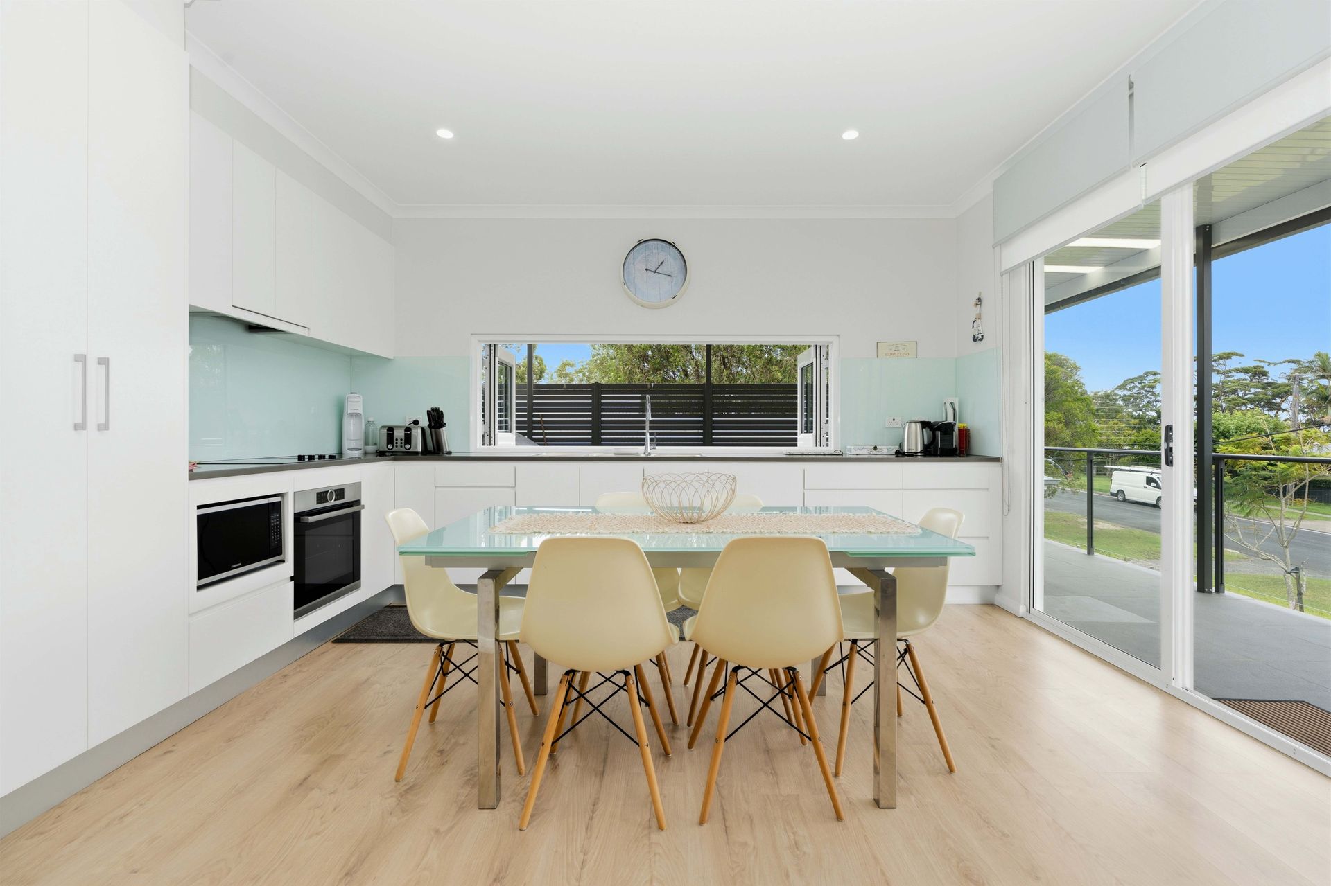 Open-plan kitchen and dining area with sliding doors onto the upstairs balcony